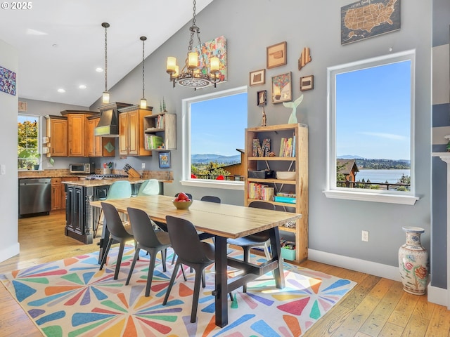 104 S Pl, Astoria, OR 97103 - dining space with high vaulted ceiling, light wood-style floors, a chandelier, and recessed lighting