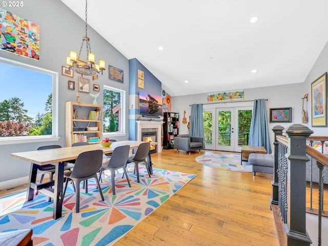 104 S Pl, Astoria, OR 97103 - dining area with plenty of natural light, a chandelier, a glass covered fireplace, high vaulted ceiling, and recessed lighting