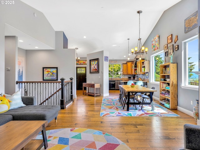 104 S Pl, Astoria, OR 97103 - dining room featuring a chandelier, healthy amount of natural light, high vaulted ceiling, light wood-style floors, and recessed lighting