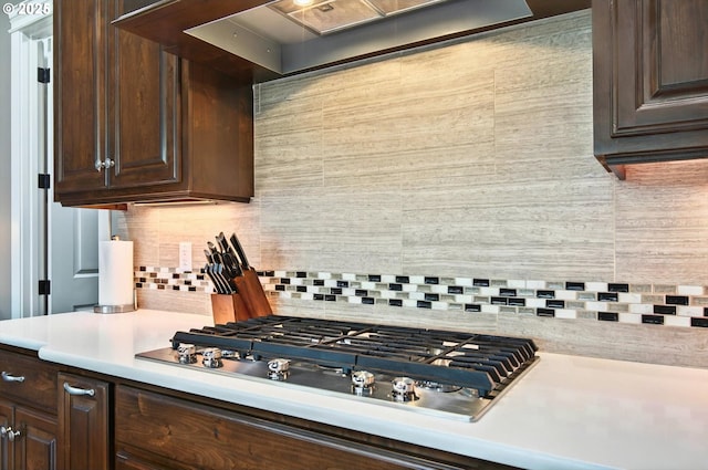 16215 NE 171st Ct, Brush Prairie, WA 98606 - kitchen featuring stainless steel gas cooktop, light countertops, dark brown cabinetry, and decorative backsplash