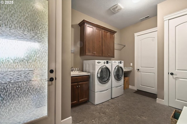 16215 NE 171st Ct, Brush Prairie, WA 98606 - washroom with washer and dryer, cabinet space, baseboards, and a textured ceiling