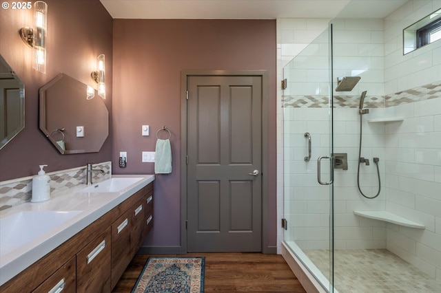 1342 11th St SW, Bandon, OR 97411 - full bathroom with a shower stall, wood finished floors, and double vanity