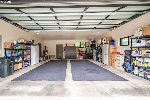 1342 11th St SW, Bandon, OR 97411 - garage featuring freestanding refrigerator and strapped water heater