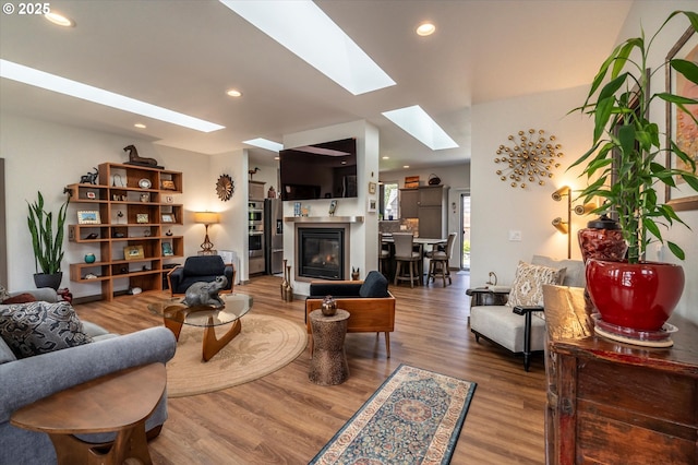 1342 11th St SW, Bandon, OR 97411 - living room featuring a skylight, wood finished floors, recessed lighting, and a glass covered fireplace