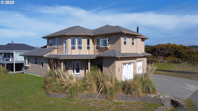 54179 Gould Rd, Bandon, OR 97411 - back of house featuring driveway, an attached garage, a lawn, and a shingled roof