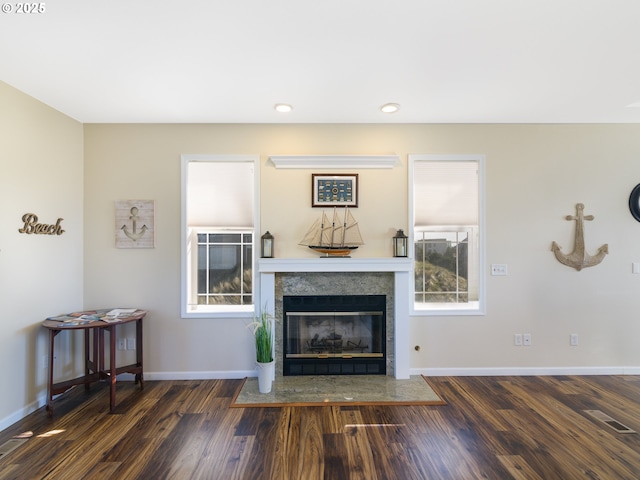 54179 Gould Rd, Bandon, OR 97411 - living area featuring wood finished floors, baseboards, a tile fireplace, healthy amount of natural light, and recessed lighting