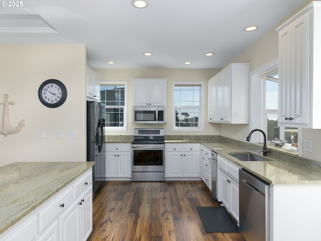 54179 Gould Rd, Bandon, OR 97411 - kitchen with stainless steel appliances, a sink, white cabinets, recessed lighting, and light stone countertops