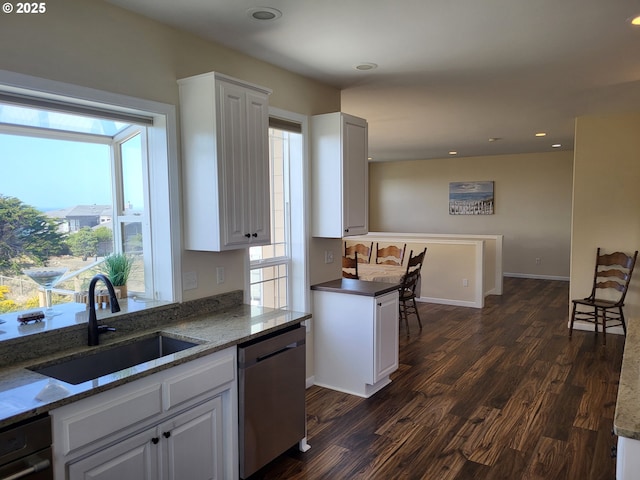 54179 Gould Rd, Bandon, OR 97411 - kitchen featuring stainless steel dishwasher, a sink, healthy amount of natural light, dark wood-type flooring, and recessed lighting