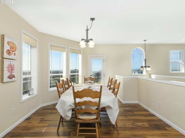 54179 Gould Rd, Bandon, OR 97411 - dining space with a chandelier, baseboards, and dark wood-style floors