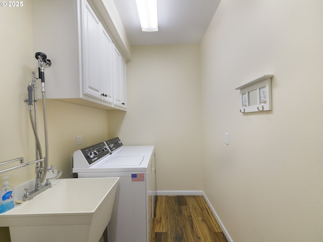 54179 Gould Rd, Bandon, OR 97411 - laundry room with dark wood finished floors, independent washer and dryer, cabinet space, and baseboards