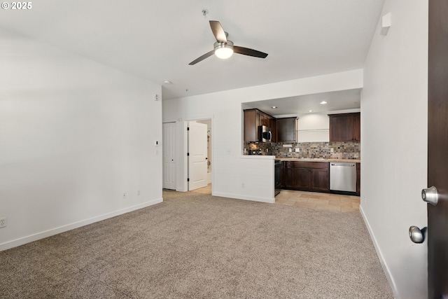 672 NE Newstead Ln, Hillsboro, OR 97006 - unfurnished living room featuring light colored carpet, a ceiling fan, baseboards, a sink, and recessed lighting