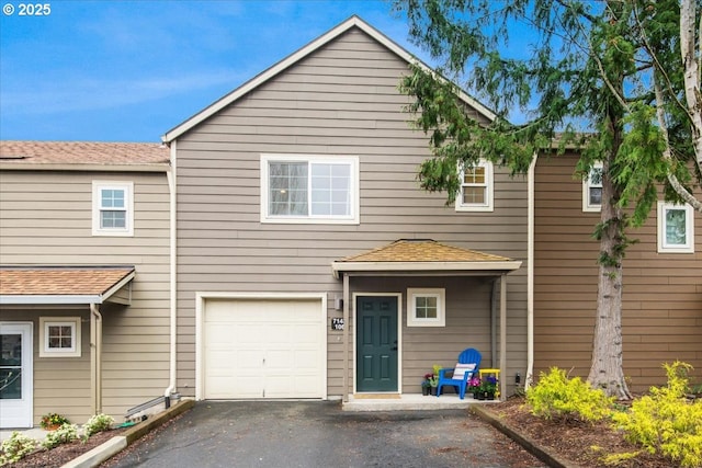 7143 SW Sagert St Unit 106, Tualatin, OR 97062 - rear view of property with driveway and an attached garage