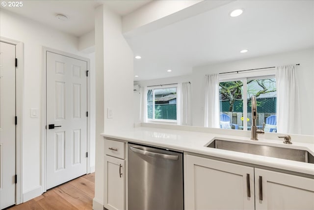 7143 SW Sagert St Unit 106, Tualatin, OR 97062 - kitchen with dishwasher, light wood finished floors, a sink, healthy amount of natural light, and recessed lighting