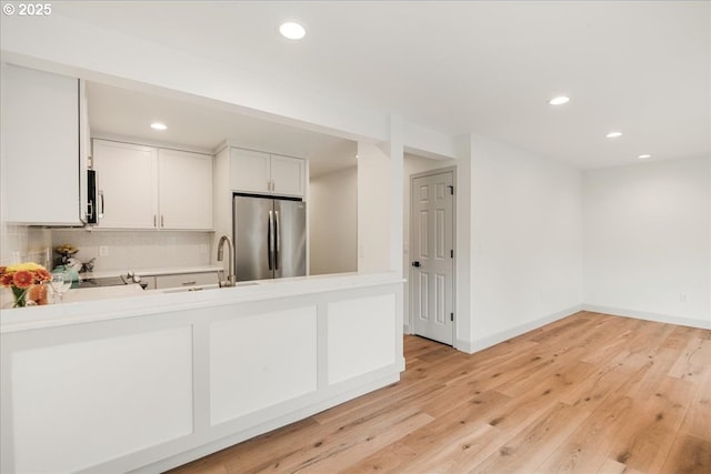 7143 SW Sagert St Unit 106, Tualatin, OR 97062 - kitchen featuring freestanding refrigerator, a sink, recessed lighting, light countertops, and tasteful backsplash