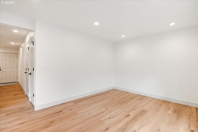 7143 SW Sagert St Unit 106, Tualatin, OR 97062 - unfurnished room featuring an AC wall unit, recessed lighting, light wood-style flooring, and baseboards