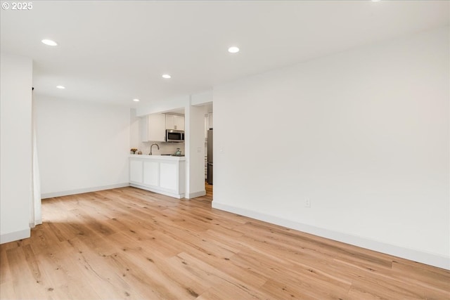 7143 SW Sagert St Unit 106, Tualatin, OR 97062 - unfurnished room with recessed lighting, light wood-style floors, and baseboards