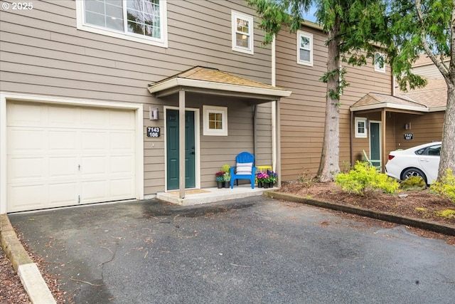 7143 SW Sagert St Unit 106, Tualatin, OR 97062 - view of front of property with an attached garage and asphalt driveway
