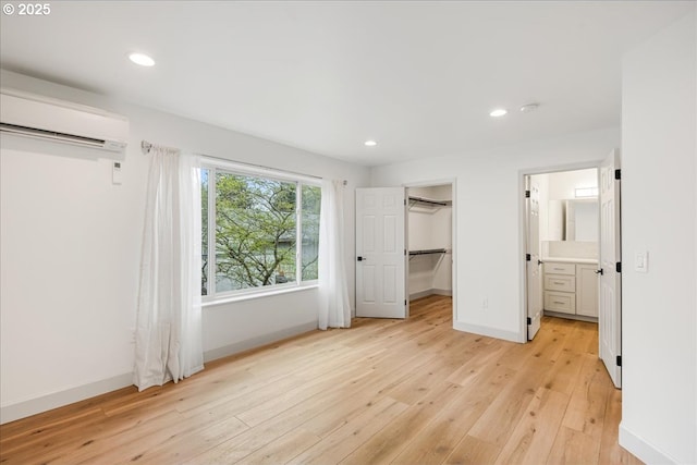 7143 SW Sagert St Unit 106, Tualatin, OR 97062 - empty room with a wall unit AC, light wood finished floors, recessed lighting, and baseboards