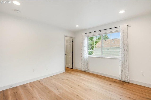 7143 SW Sagert St Unit 106, Tualatin, OR 97062 - unfurnished bedroom with light wood-style flooring, recessed lighting, baseboards, and a closet