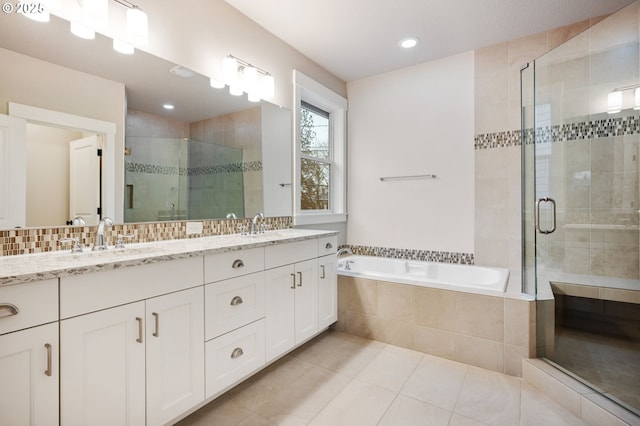 bathroom featuring tile patterned flooring, vanity, and shower with separate bathtub