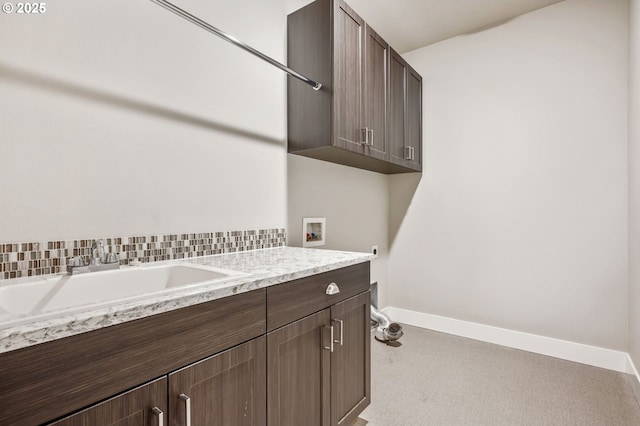 laundry area featuring sink, hookup for a washing machine, and cabinets