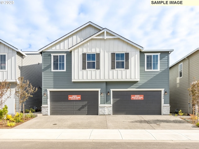 736 NW 178th Way, Ridgefield, WA 98642 - view of front of home featuring board and batten siding, an attached garage, stone siding, and driveway
