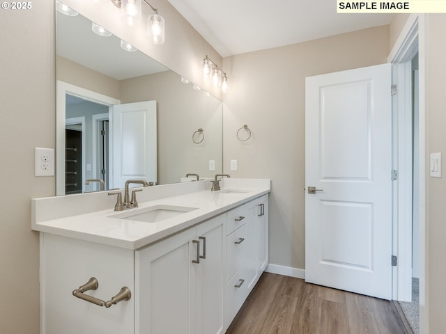 736 NW 178th Way, Ridgefield, WA 98642 - bathroom with wood finished floors, double vanity, and baseboards