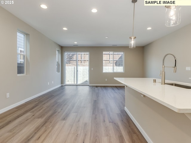 736 NW 178th Way, Ridgefield, WA 98642 - unfurnished living room with a sink, recessed lighting, baseboards, and wood finished floors