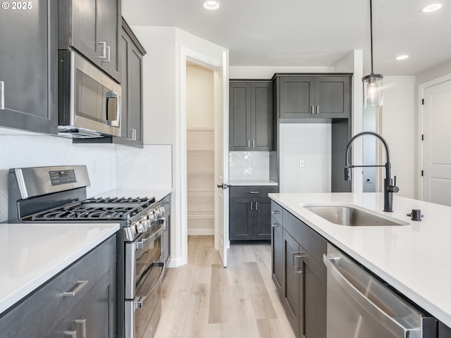 736 NW 178th Way, Ridgefield, WA 98642 - kitchen featuring stainless steel appliances, light wood-type flooring, light countertops, recessed lighting, and tasteful backsplash