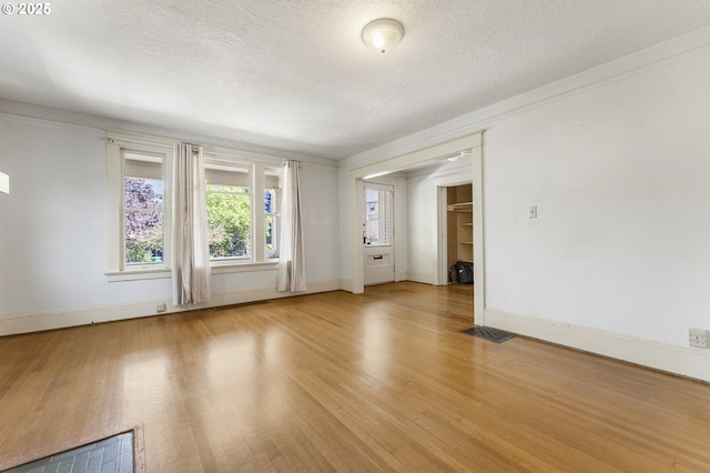 1904 SE Alder St, Portland, OR 97214 - spare room featuring light wood-style flooring, a textured ceiling, and baseboards