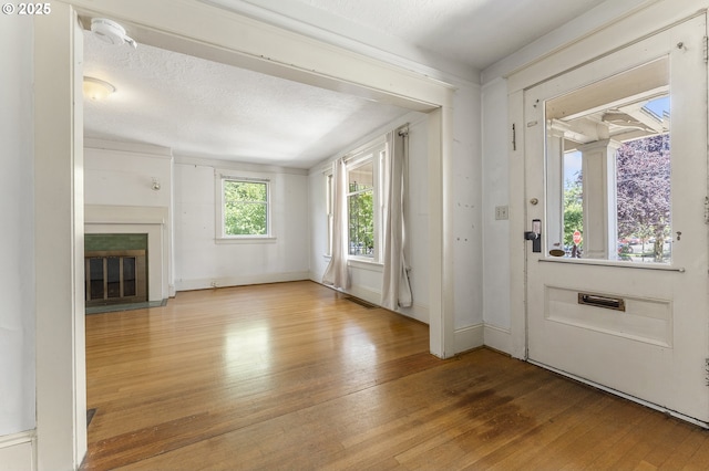 1904 SE Alder St, Portland, OR 97214 - entrance foyer featuring hardwood / wood-style floors, a glass covered fireplace, and baseboards