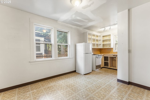 1904 SE Alder St, Portland, OR 97214 - kitchen with white appliances, baseboards, open shelves, track lighting, and light countertops