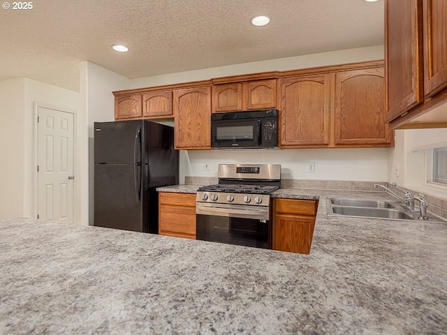 kitchen featuring sink, a textured ceiling, and black appliances