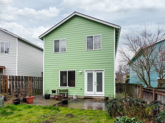 back of property with french doors, a yard, and a patio