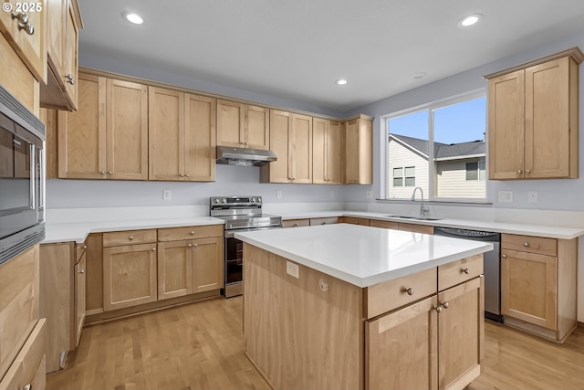 13007 SE Raymond Ct, Portland, OR 97236 - kitchen featuring stainless steel appliances, a sink, light brown cabinetry, under cabinet range hood, and light wood-style flooring