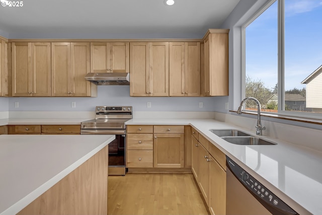 13007 SE Raymond Ct, Portland, OR 97236 - kitchen with appliances with stainless steel finishes, a sink, under cabinet range hood, light wood-type flooring, and recessed lighting