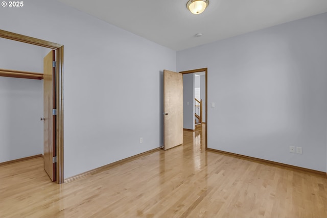 13007 SE Raymond Ct, Portland, OR 97236 - unfurnished bedroom with light wood-style flooring, a closet, and baseboards