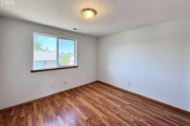 13007 SE Raymond Ct, Portland, OR 97236 - spare room with wood finished floors, baseboards, and a textured ceiling