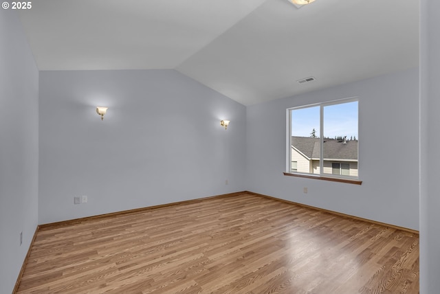 13007 SE Raymond Ct, Portland, OR 97236 - spare room featuring lofted ceiling, wood finished floors, and baseboards