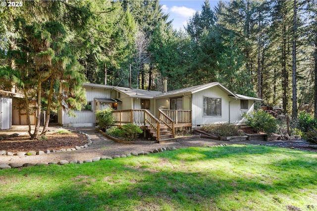 view of front of property featuring a front lawn and a deck