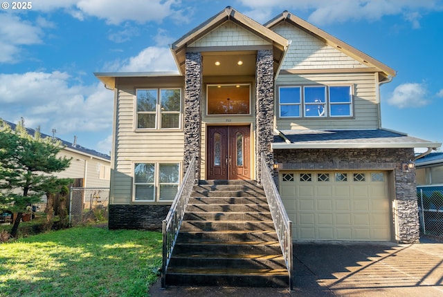 view of front of property featuring concrete driveway, an attached garage, a front yard, fence, and stone siding