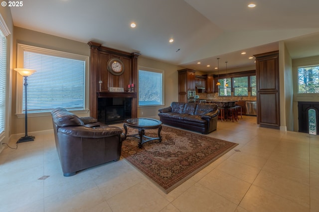703 SE Keel Ave, Lincoln City, OR 97367 - living area with a fireplace, light tile patterned floors, recessed lighting, vaulted ceiling, and baseboards