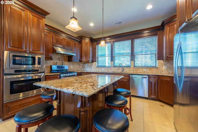 703 SE Keel Ave, Lincoln City, OR 97367 - kitchen with visible vents, appliances with stainless steel finishes, a sink, light stone countertops, and under cabinet range hood