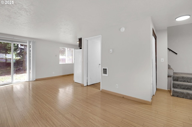 522 River Loop Unit 2, Eugene, OR 97404 - empty room with stairway, light wood-type flooring, a smoke detector, and heating unit