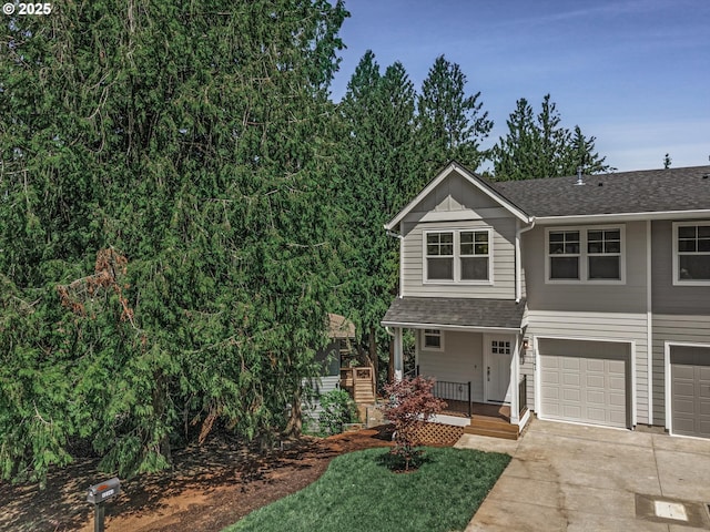 12141 SE Knapp Ln, Portland, OR 97266 - view of front of home featuring driveway, a porch, an attached garage, and a shingled roof