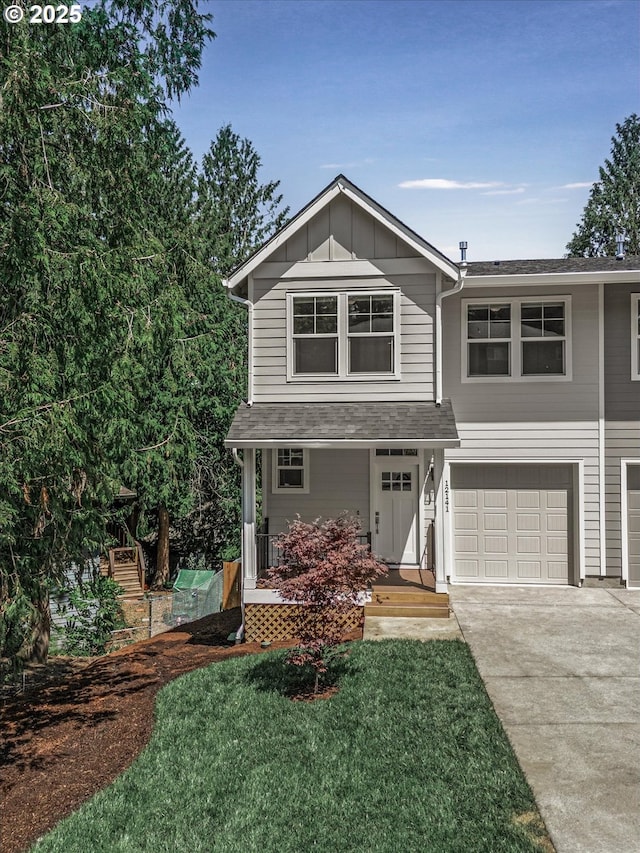 12141 SE Knapp Ln, Portland, OR 97266 - view of front of house with driveway, covered porch, a garage, board and batten siding, and roof with shingles