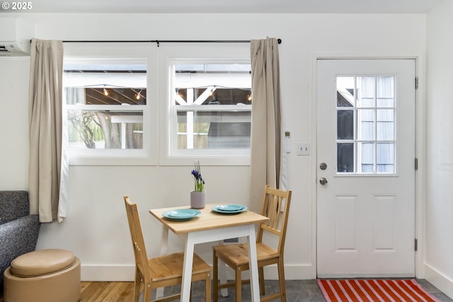 dining room featuring wood finished floors and baseboards