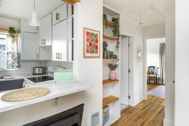 kitchen featuring visible vents, decorative backsplash, light countertops, open shelves, and white range with electric cooktop