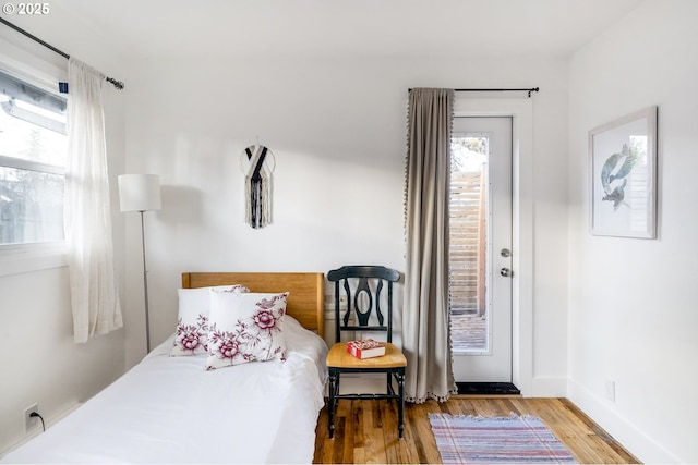 bedroom with baseboards and wood finished floors