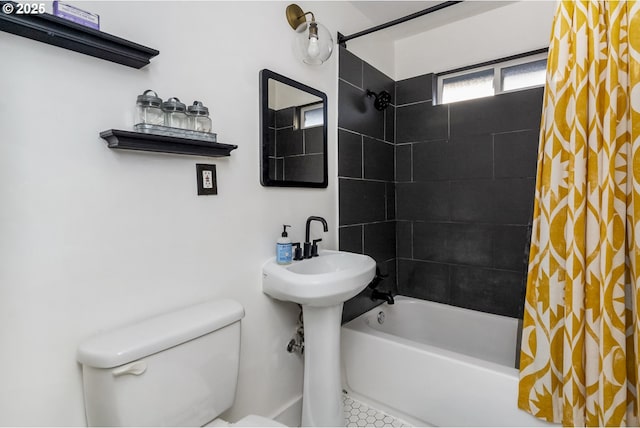 bathroom featuring shower / tub combo and toilet